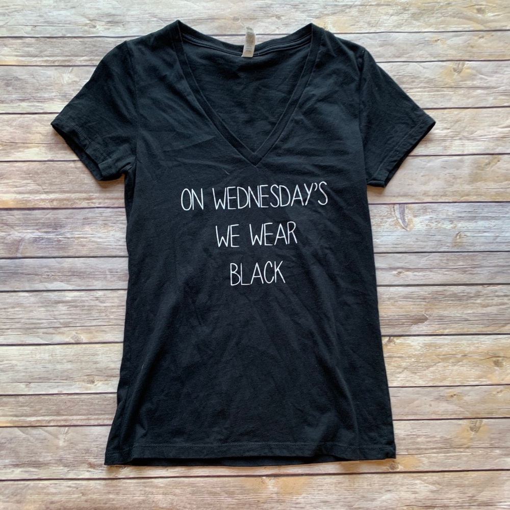 “On Wednesday’s. We Wear Black” v-neck Tee.